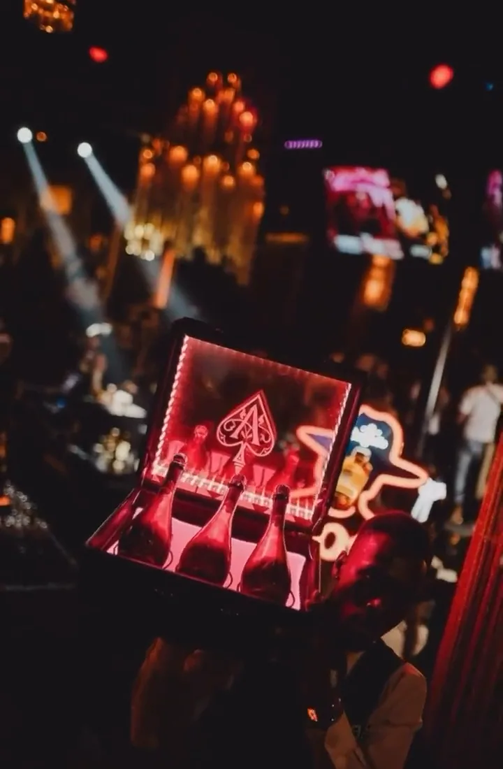 Neon spade bottle box carried through the room
